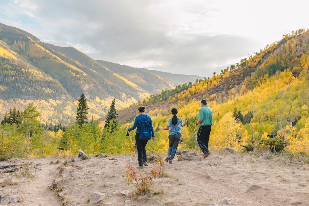 family of three hiking in the colorado mountains