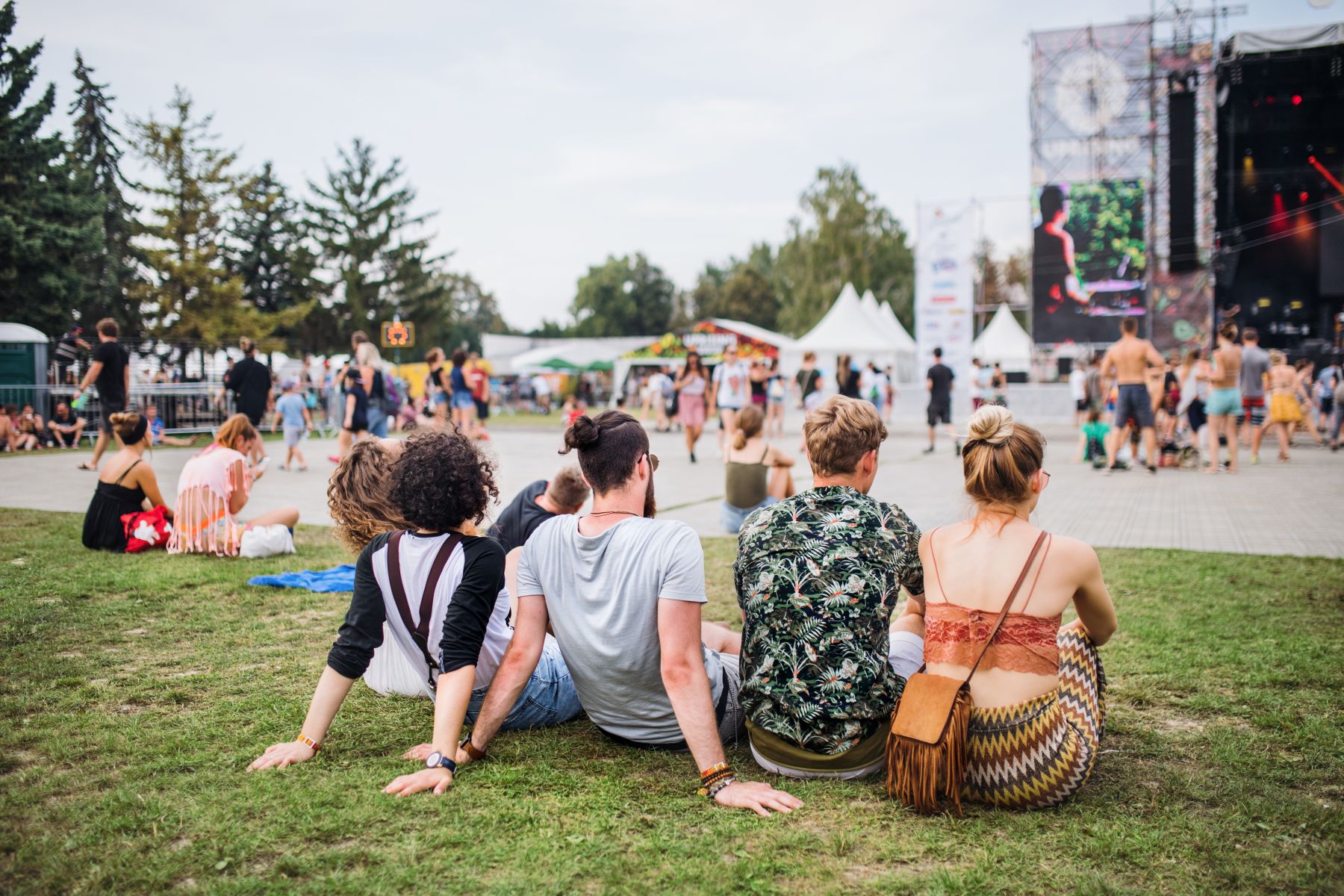 group of friends sitting at an outdoor music concert