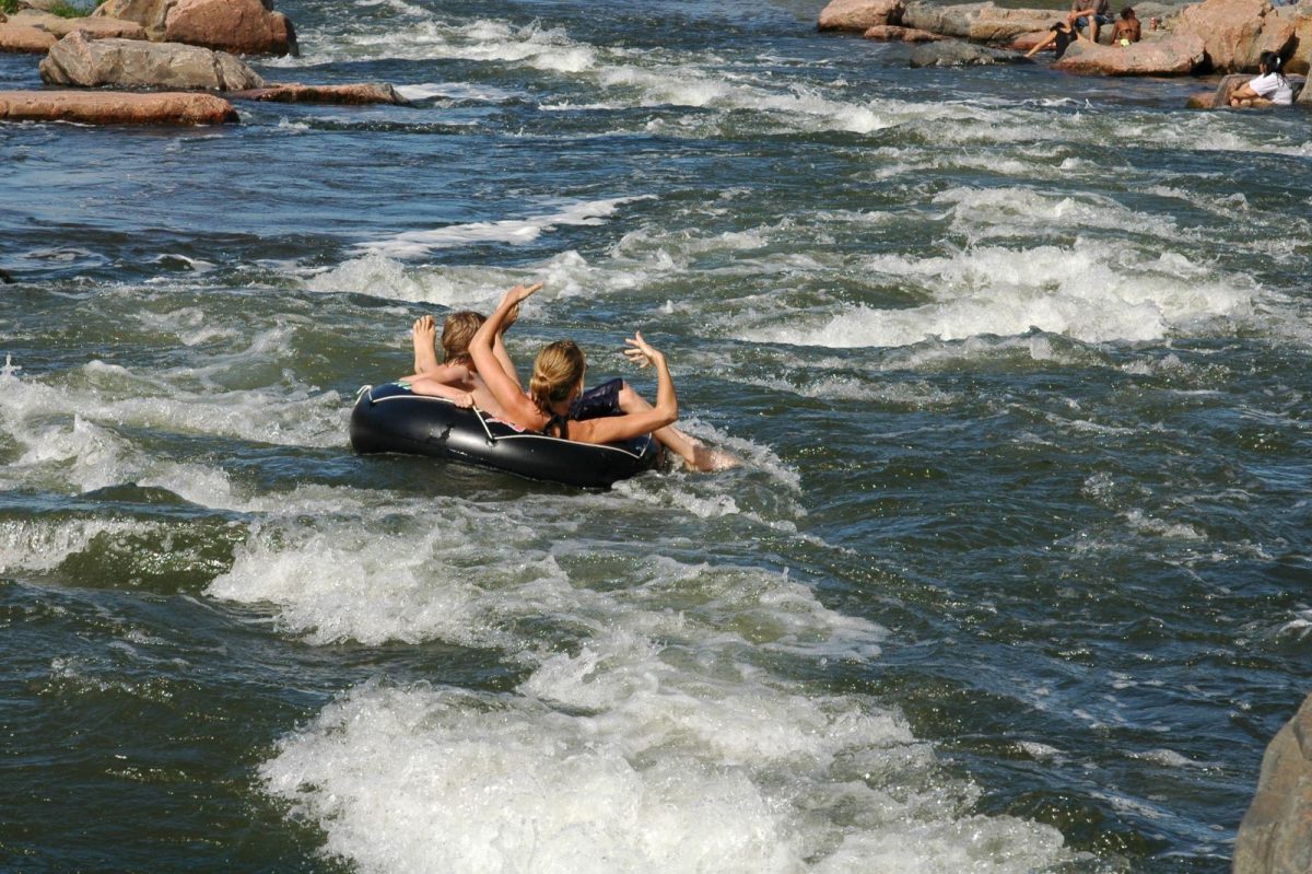 people floating in tub down river